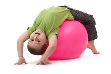 Boy exercising with a therapy ball